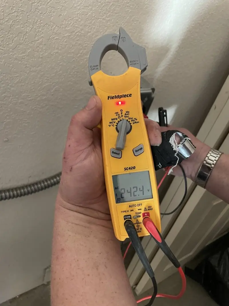 Voltage testing with clamp meter during Recessed Lighting Installation in Derry